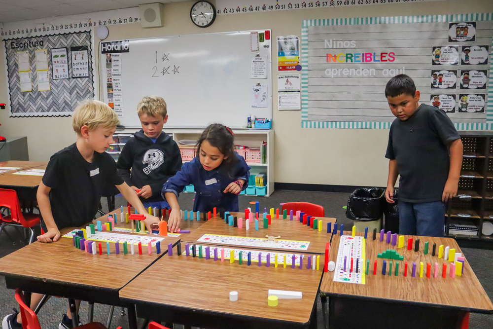 Students from Ready, Set, Engineer build a domino train