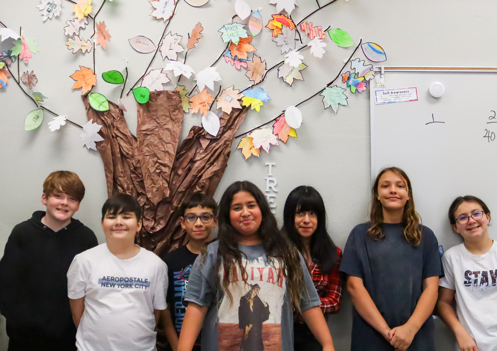 Students in front of their strengths tree